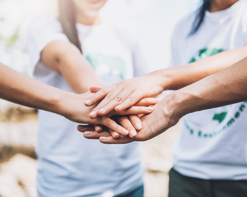 close-up-people-volunteer-teamwork-putting-finger-star-shapehands-togetherstack-handsunity-teamwork-world-environment-day